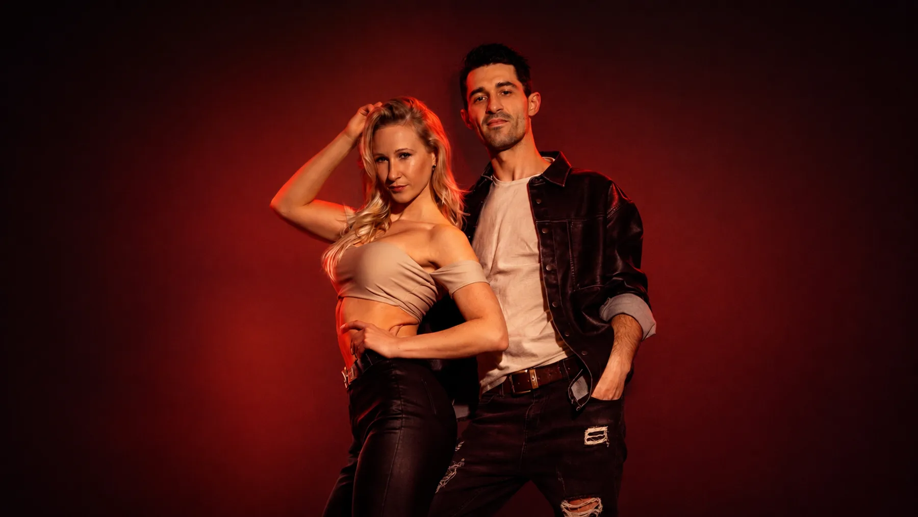 Alexej & Florence under red studio lighting — Brazilian Zouk workshops and bootcamps